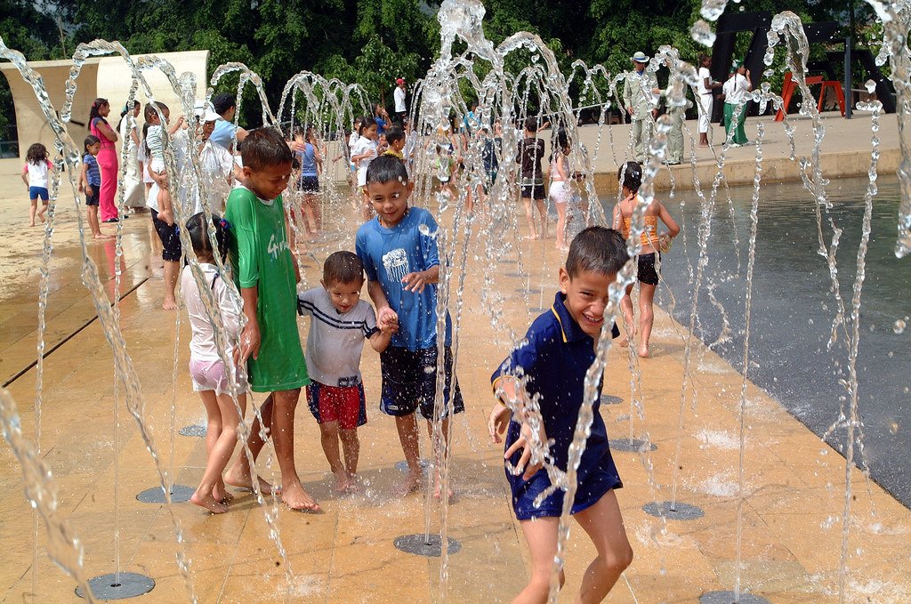 Niños jugando en un parque hídrico urbano que reutiliza el agua, ejemplo de gestión sustentable del recurso hídrico en entornos comunitarios